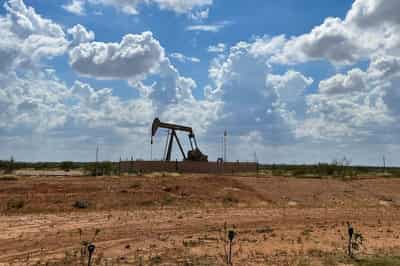 Image for Oil prices fall on supply forecast, easing risk