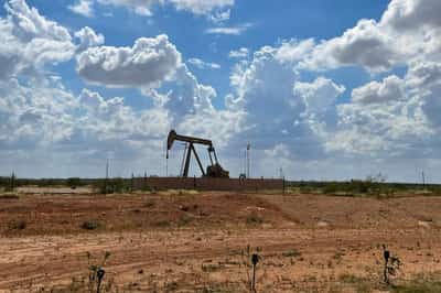 Image for Oil prices fall on supply forecast, easing risk