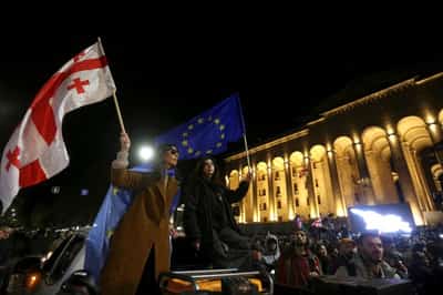 Image for Georgian police raid homes of activists providing financing to anti-government protesters