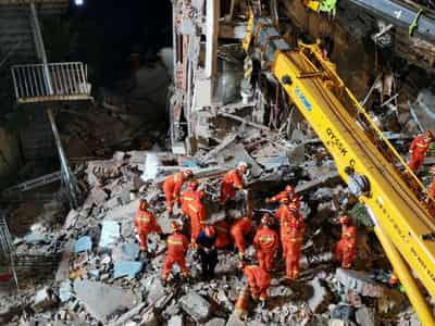 Image for China hotel collapse kills eight; rescuers search for nine missing