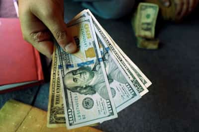 Image for Dollar near two-week lows as rate-hike bets recede, embattled yen in focus