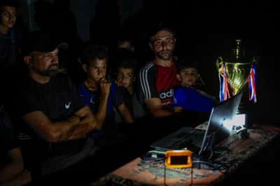 Image for Gazans displaced by war watch World Cup from the ruins