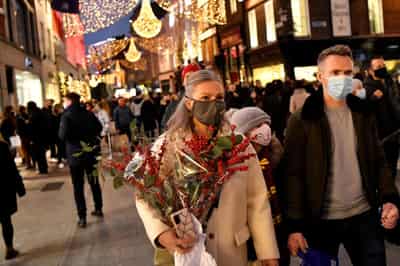 Image for Heavy winter sweaters, coats pile up at stores as warm weather threatens holiday shopping season