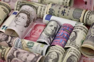 Image for US dollar slides ahead of central bank meetings, key data this week