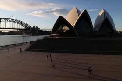 Image for Analysis: Shut off from the world, Australia fosters red-hot growth at home