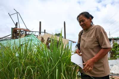 Image for 'Thank God, we fled': Thai grandmother returns to ruined home after border conflict