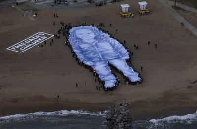 Image for Giant portrait of girl killed in Gaza war unfurled on Barcelona beach