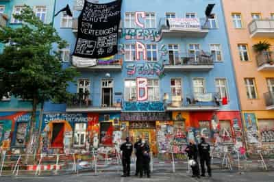Image for Berlin police force entry to long-time squat under hail of fireworks, smoke bombs