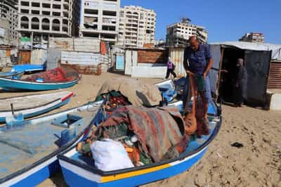 Image for Gazan fishermen patch up dinghies with door frames to keep themselves afloat