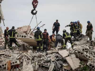 Image for Ukraine apartment block toll rises as Zelenskiy laments Russian firepower advantage
