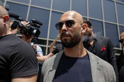 Image for Andrew Tate, charged with rape and trafficking in Romania, lands in the US
