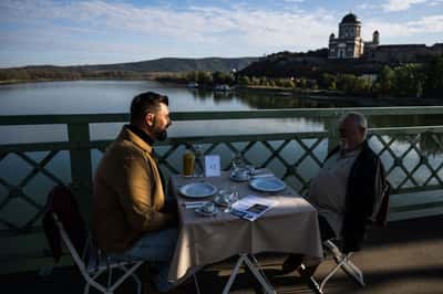 Image for Hungarians and Slovaks share breakfast on Danube bridge that survived war and division
