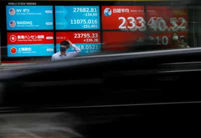 Image for Rosy earnings lift US stocks to record peaks, dollar at 1-month low