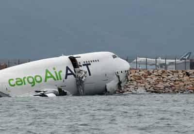 Image for Cargo plane slides off runway in Hong Kong, killing two airport staff