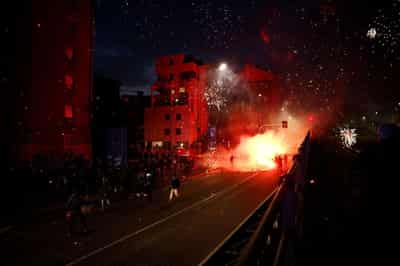 Image for Hooded protesters throw flares at police at end of demonstration in Olympic host city Milan