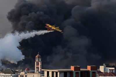 Image for Greek firefighters battle fire at business site, at least two injured