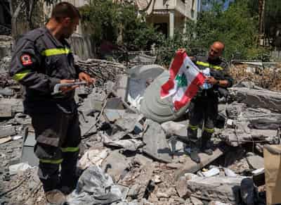 Image for In Lebanon, first responders salvage memories from debris of destroyed HQ