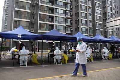 Image for Beijing shoppers clear store shelves as district starts mass testing