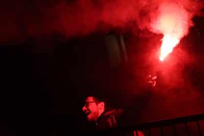 Image for Police fire water cannon at protesters hurling smoke bombs in Olympic host Milan