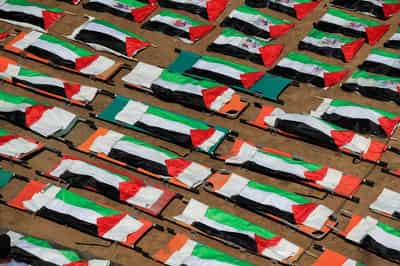 Image for Gazans bury nearly a whole clan found in rubble in mass funeral for 112