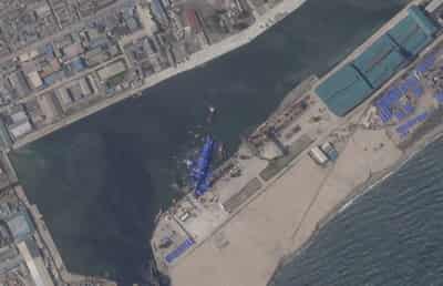 Image for North Korea pulls capsized warship upright after botched launch, report says