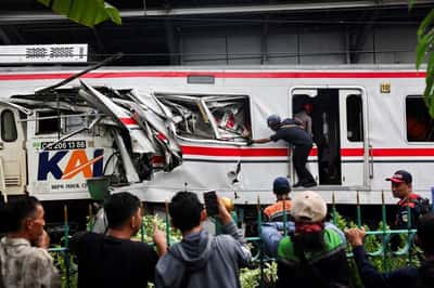 Image for Indonesia train crash toll rises to 14 as rescuers work to remove trapped passengers