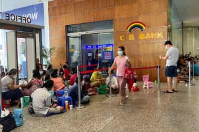 Image for Lines, tokens and money brokers: Myanmar&#8217;s crumbling economy runs low on cash