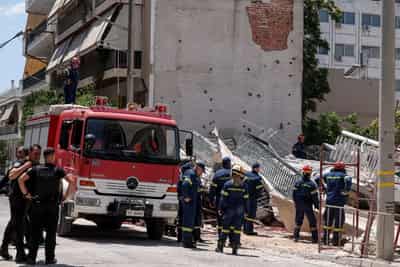 Image for Four trapped after residential building collapses in Athens, fire brigade says