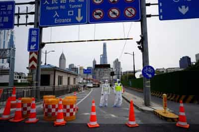 Image for Shanghai locks down as COVID surges in China’s financial hub