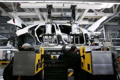 Image for Electric vehicle makers burning cash, slammed by sky-high costs