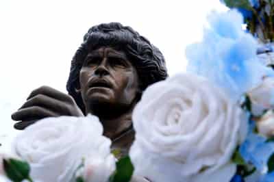 Image for Soccer-Maradona statue rides through Naples as city remembers Argentine great