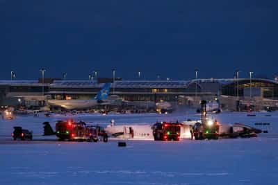 Image for Delta plane flips upside down on landing at Toronto airport, injuring 18