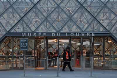 Image for French police hunting stolen Louvre jewels arrest more suspects