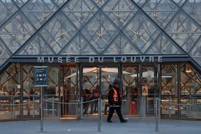 Image for French police hunting stolen Louvre jewels arrest more suspects