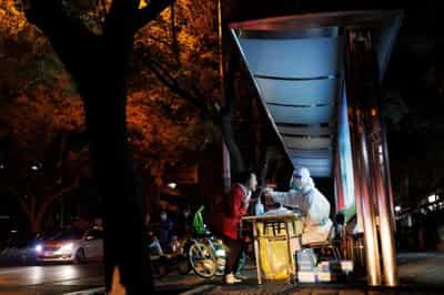Image for New China COVID rules spur concern as some cities halt routine tests