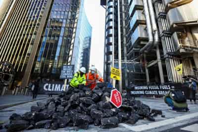 Image for Activists dump fake coal outside Lloyd&#8217;s of London in fossil fuel protest