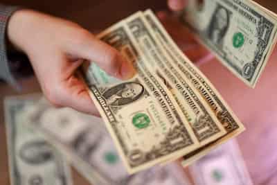 Image for Dollar holds steady on safe-haven demand, ends down on the week