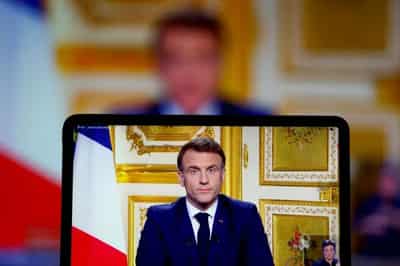 Image for Macron, defying calls to resign, struggles on in search for stable French government